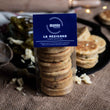 Load image into Gallery viewer, packaged La Mexicana savoury welsh cakes with a blue MamGu Welshcakes label, on a busy table with loose welsh cakes, jalapenos, cheese and rolling pin.