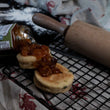 Load image into Gallery viewer, Vegan Cheese and Leek Welsh Cakes on a cooling rack with a chutney on top