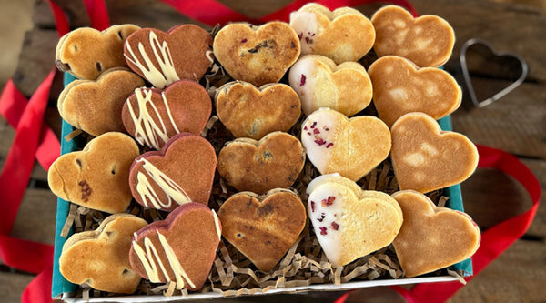 A neatly presented gift box of 20 artisan decorated heart shaped welsh cakes for valentines day
