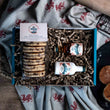 Load image into Gallery viewer, Packaged Barti Spiced Rum &amp; Raisin Welsh Cakes with a miniature Barti Spiced Rum bottle and a miniature Barti Cream bottle in a gift box on a table cloth with welsh dragons. 
