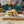 Load image into Gallery viewer, Stack of Banoffee Welsh Cakes on a wooden board with a blurred background
