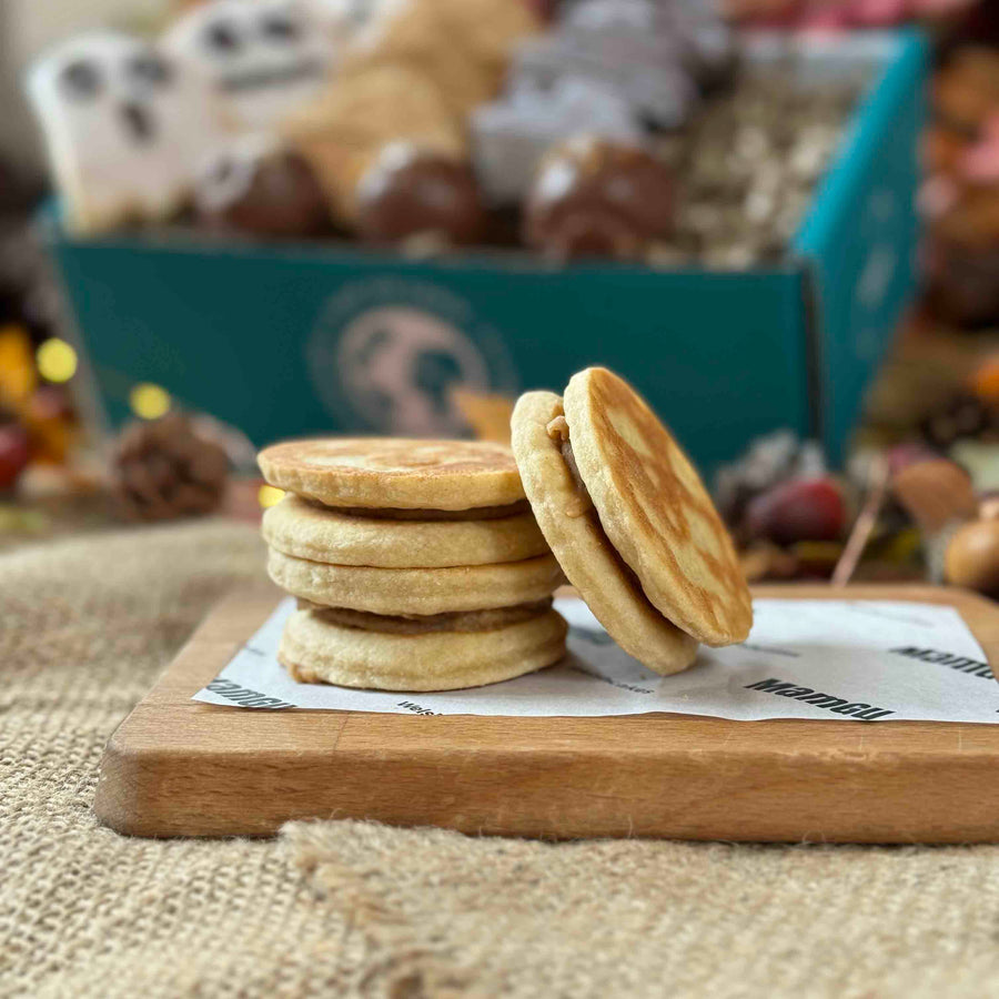 Stack of Banoffee Welsh Cakes on a wooden board with a blurred background