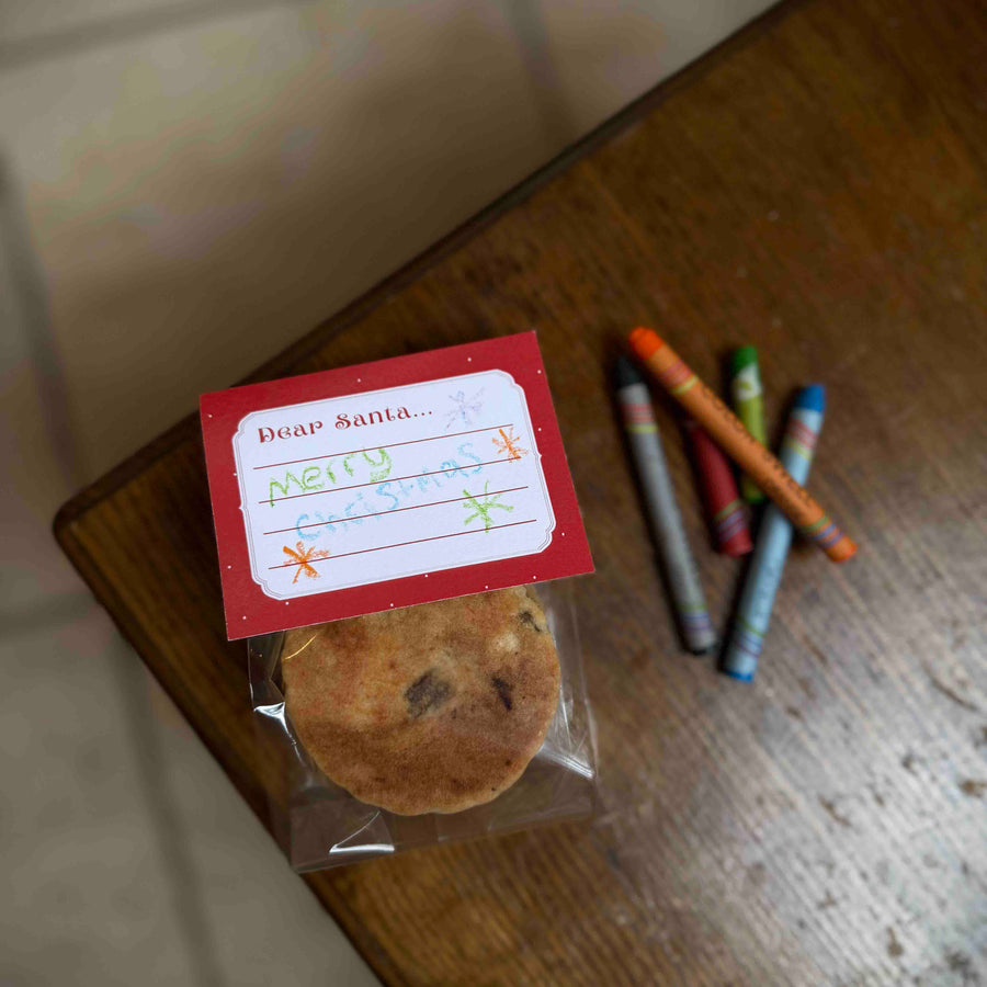 2 pack of traditional welsh cakes with a space for children to write a note or draw a picture for Santa. Displayed on a wooden table next to crayons