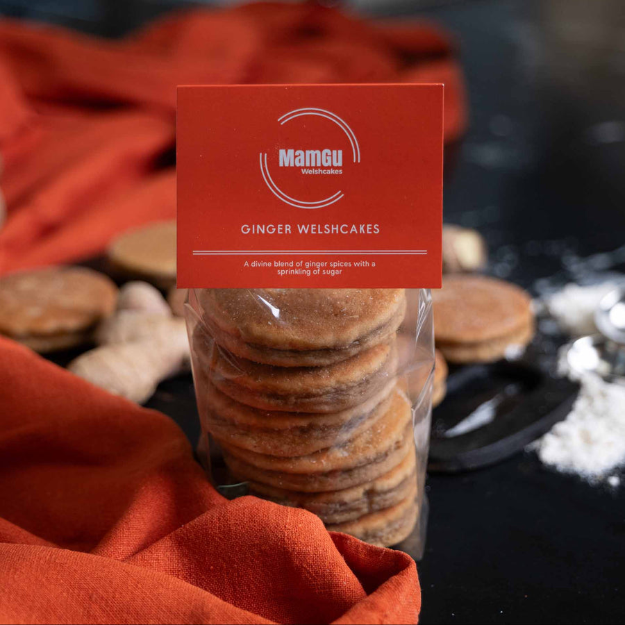 packaged ginger welsh cakes with a mamgu welshcakes label, orange table cloth on a black work top