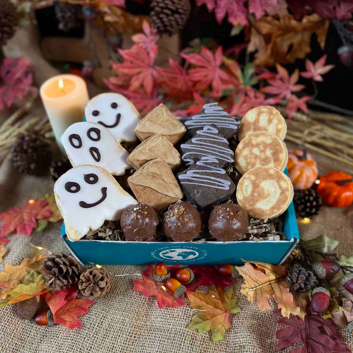 Halloween Welsh Cakes neatly displayed in a blue gift box next to autumn themed table decorations 