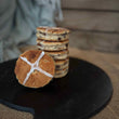 Load image into Gallery viewer, 6 Hot Cross Bun Welshcakes stacked on top of each other presented on a black bakestone / griddle, with a hessian and wood background. 

