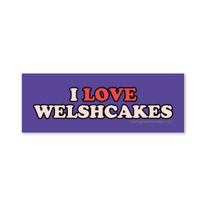A rectangular purple bumper sticker with the text 'I LOVE WELSHCAKES' in red and white lettering, shown on a plain white background.
