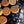 Load image into Gallery viewer, Lemon Welshcakes on a griddle with flour and cut lemons
