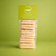 Load image into Gallery viewer, 6 Lime and Coconut Welsh Cakes stacked in a bag with a mamgu welshcakes label on top and a green background.
