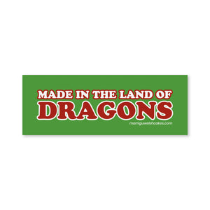 A rectangular green sticker or sign with the phrase “MADE IN THE LAND OF DRAGONS” in large red letters outlined in white.