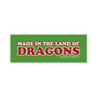 Load image into Gallery viewer, A rectangular green sticker or sign with the phrase “MADE IN THE LAND OF DRAGONS” in large red letters outlined in white.
