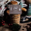 Load image into Gallery viewer, Packaged Mince Pie Welsh Cakes with a MamGu Welshcakes label and surrounded by Christmas decorations

