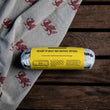 Load image into Gallery viewer, Roll of ready-to-bake Welsh cake dough on a wooden surface with a Welsh patterned cloth.
