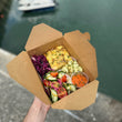 Load image into Gallery viewer, Take Away Lunch in a brown box with a harbour in the background
