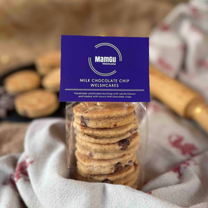 Packaged Milk Chocolate Chip Welsh Cakes with purple mamgu welshcakes branding on a rustic kitchen work top