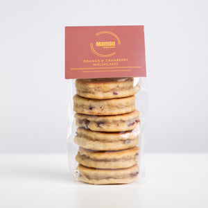 Orange and Cranberry Welsh Cakes in clear packaging with a white background