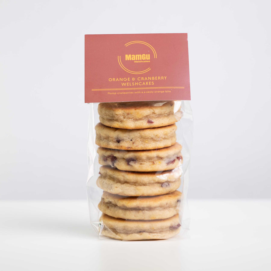Orange and Cranberry Welsh Cakes in clear packaging with a white background
