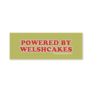 A rectangular olive green sticker or decal with the text 'POWERED BY WELSHCAKES' in large red letters outlined in white.
