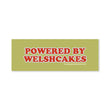 Load image into Gallery viewer, A rectangular olive green sticker or decal with the text 'POWERED BY WELSHCAKES' in large red letters outlined in white.
