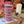 Load image into Gallery viewer, Stack of Purple Parma Violets Welsh Cakes on a wooden board with Autumn-themed decorations in the background.
