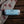 Load image into Gallery viewer, Roll of ready-to-bake Welshcake dough on a wooden surface with a welsh dragon patterned cloth.
