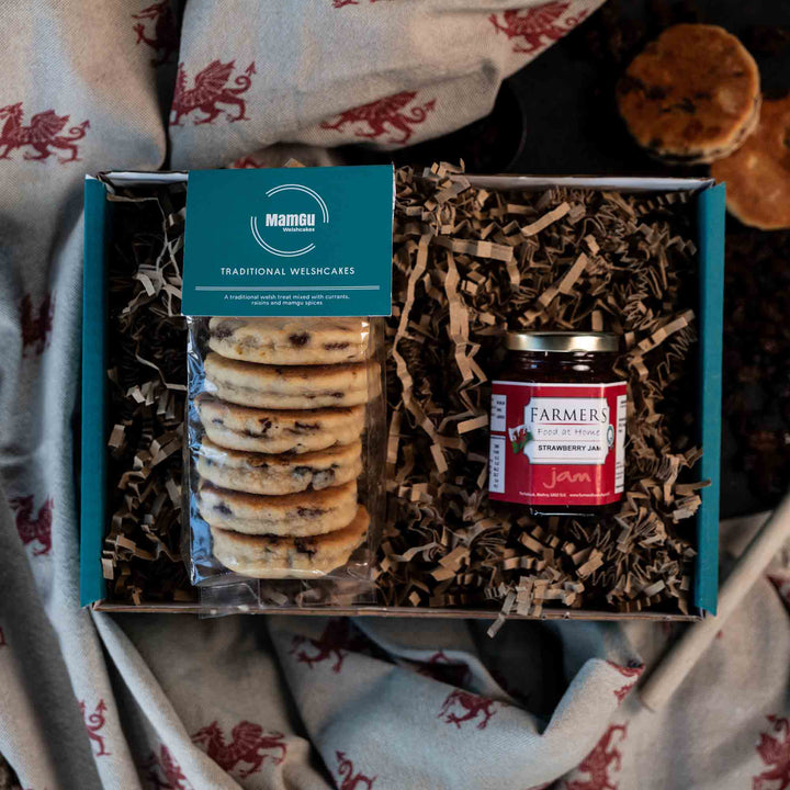 Gift Box with packaged Traditional Welsh Cakes and Strawberry Jam on a Welsh dragon table cloth