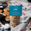 Load image into Gallery viewer, Packaged Traditional Welsh Cakes with a MamGu Welshcakes label on busy kitchen background with welsh dragon table cloth and welsh cakes on a griddle. Great Taste Award 1 gold star badge in the top left corner of the image. 
