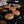Welsh Cakes on a griddle with ingredients, spices, raisins on the side