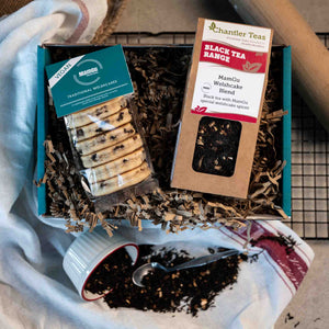 Tea packaged with Vegan Traditional Welsh Cakes in a gift box on a busy kitchen worktop