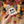 Load image into Gallery viewer, Hand holding a ghost-shaped welsh cake with a blurred Halloween-themed background

